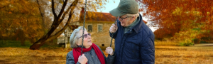 Older Adult Couple on a swing looking at each other talking