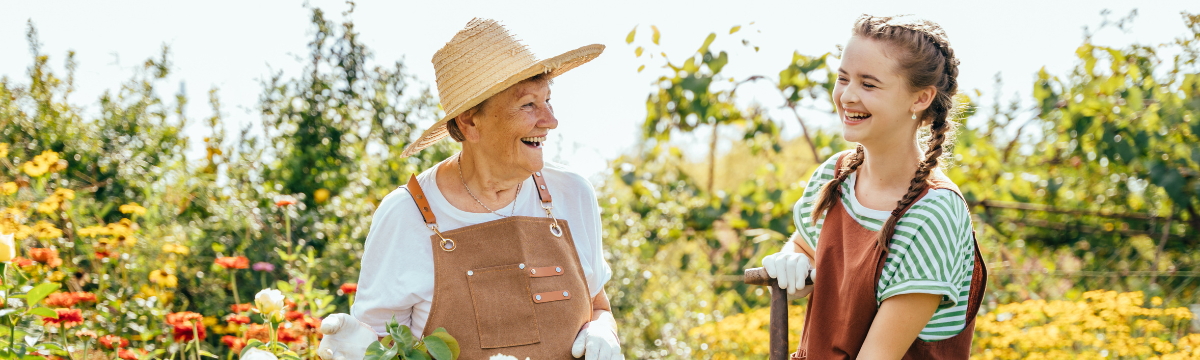 Older Adult woman and teenage girl gardening