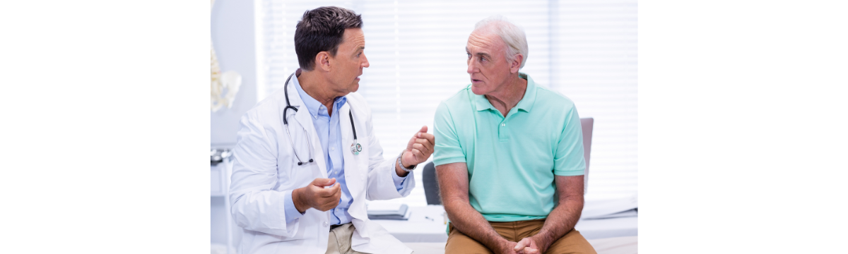 Older adult man talking with doctor