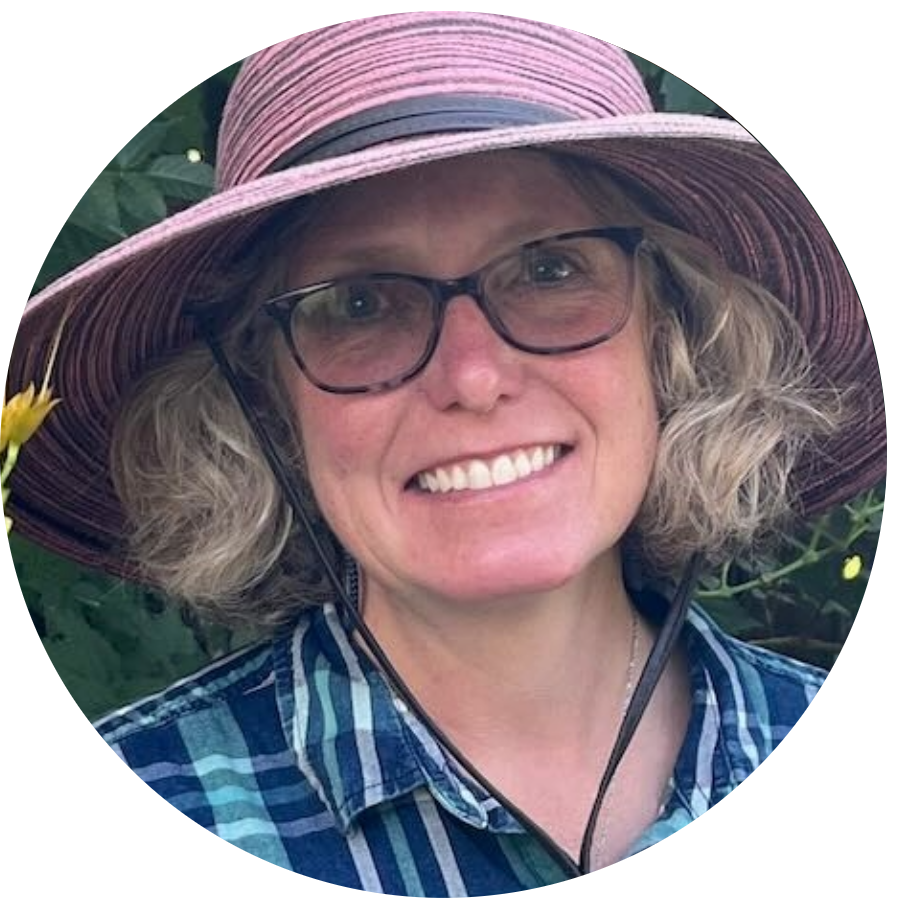 Ami Erickson, Horticulture and Life Sciences Instructor at Sheridan College, Standing in Front of Bush Wearing Purple Hat and Blue Flannel Shirt - Profile Picture