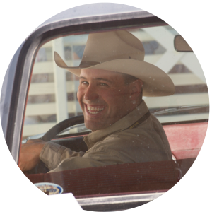 Jeremiah Vardiman, University of Wyoming Extension Soils Specialist, Smiling with Cowboy Hat, seen through an old truck rear view window - profile picture