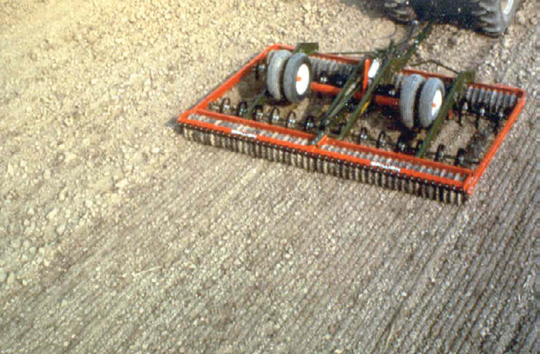 photo of drag pullled by tractor, preparing the seedbed
