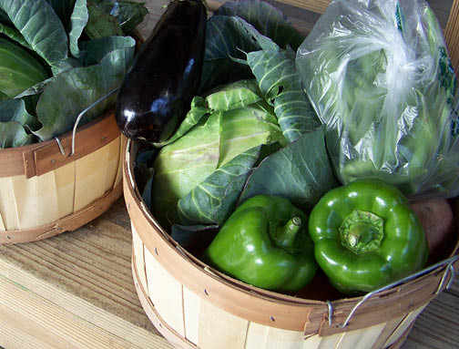 wood basket with assorted green vegetables