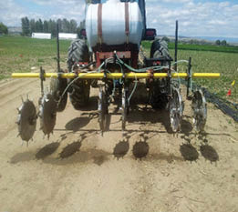 Tractor with fertilizer applicator attachment