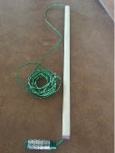 Green sensor wire is run through a length of white PVC pipe 