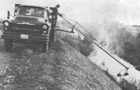 Historical photo of truck with boom-mounted nozzle 