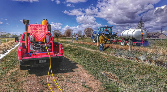 Irrigation ditch with trucks on each side 
