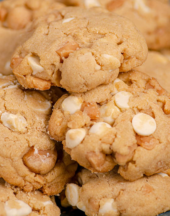 A close-up of chunky macadamia nut white chocolate cookies. 