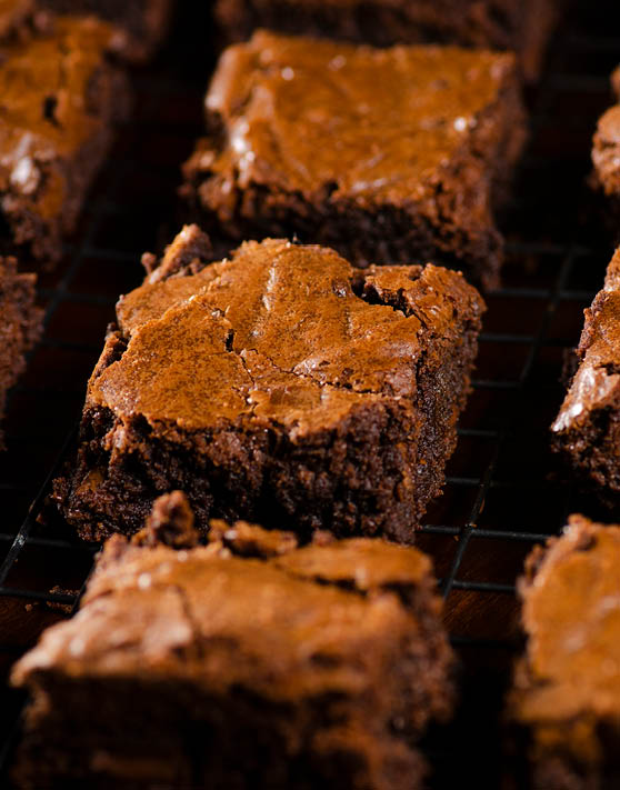 A close up of a row of fudge brownies. 