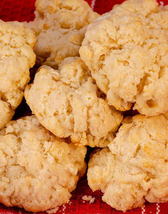 Baking powder drop biscuits on a red dish towel. 