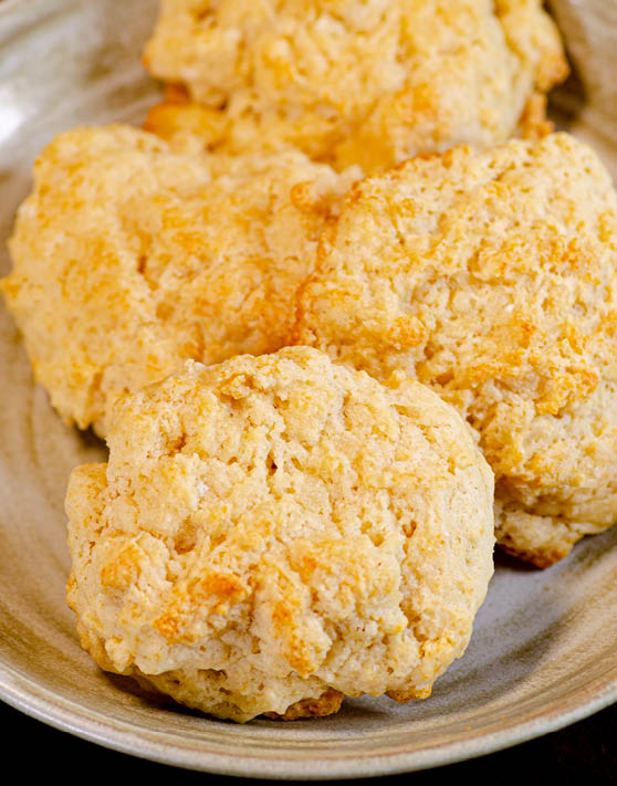 Buttermilk drop biscuits placed on a beige plate. 