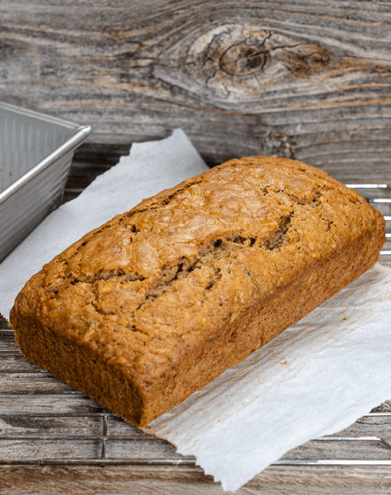 A loaf of zuccchini bread placed on a white paper towel. 