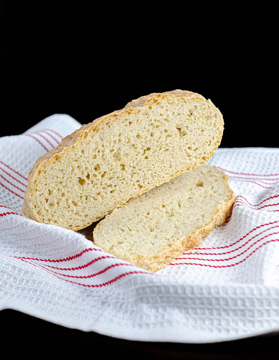 Easy bowl peasant bread placed on top of a red and white towel. 