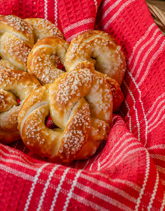 Soft pretzels in a red and white dish towel. 