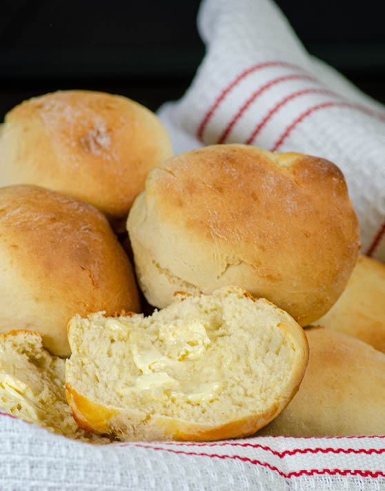 Quick honey rolls placed in a white and red dish towel. 