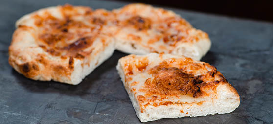 Small cheese pizza baked on artisan-style pizza crust. 
