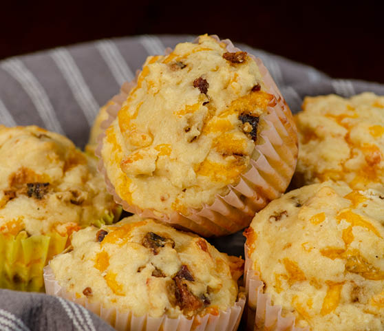 A basket of caramelized bacon and cheese muffins. 