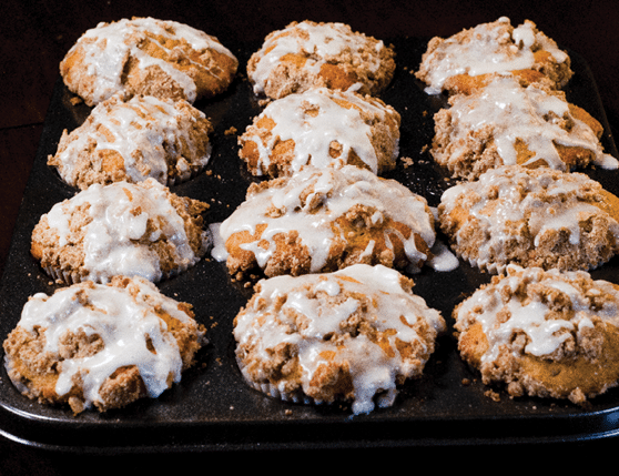 Fruit oatmeal streusel muffins arranged in columns on a pan. 