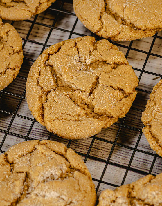 A close up of chewy peanut butter cookies on a cooling rack. 