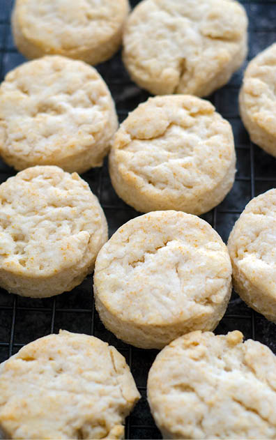 Baked biscuits on a black mesh cooling rack 