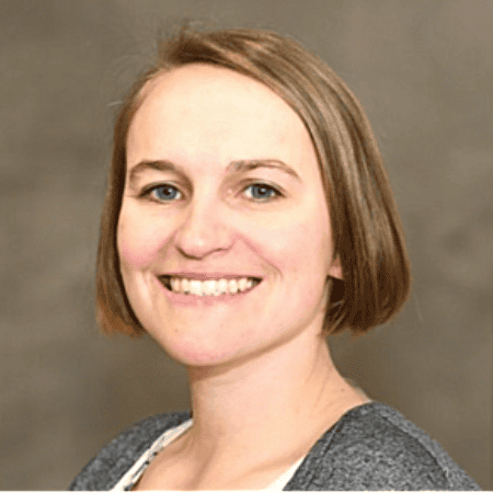 Ashley Stegeman: A close-up of Ashley Stegeman smiling in front of a neutral background, with short, straight hair and a friendly expression.