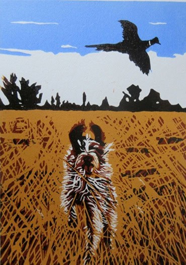 A stylized print of a hunting dog running through a golden field of tall grass, its fur rendered in bold, textured lines of brown, white, and black. In the sky above, a pheasant is captured mid-flight against a backdrop of blue sky and white clouds, with dark silhouettes of trees lining the horizon.