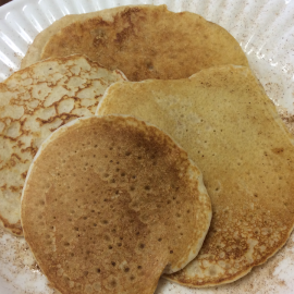 four cooked pancakes on a white plate
