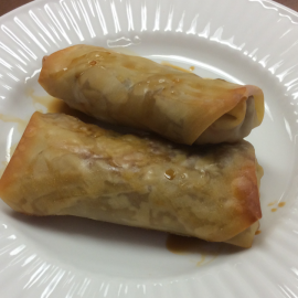two egg rolls on white plate