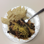 recipe serving on white plate with tortilla chips and fork