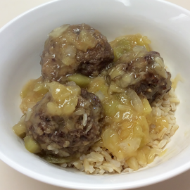 3 meatballs with sauce in white bowl