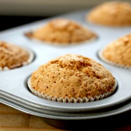 baked muffins in papers in metal baking tin