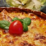 baked dish topped with tomato and basil