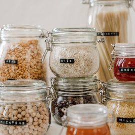 glass jars of dry goods with labels; Rice label in focus in the middle