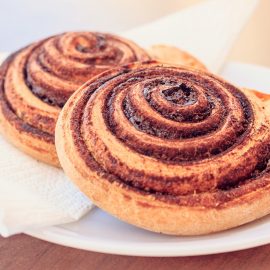 two cinnamon rolls on a white plate
