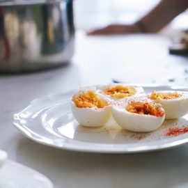 eggs on white plate in kitchen background