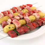 uncooked meat and potatoes on BBQ skewers