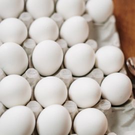 carton of 18 white eggs with 2 empty
