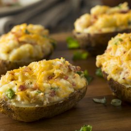 four twice baked potatoes with toppings