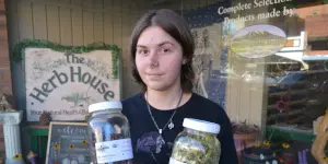 Elk Mountain Herbs employee displays herb jars.