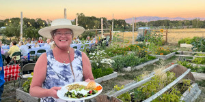 Woman with plate in a garden