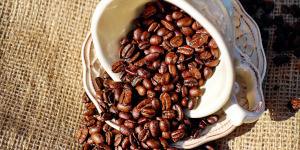 Coffee beans spilling out of cup