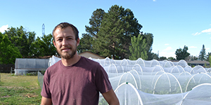 Man standing next to covered gardens