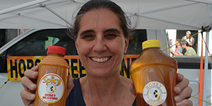 Woman holding bottles of honey