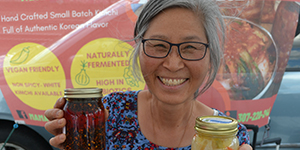 Booyong Kim holding two jars