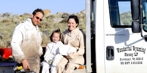 Family sitting on truck bed
