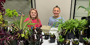 Two children with plants