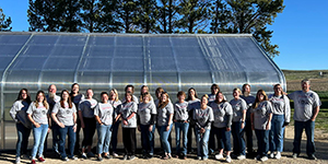 Students in front of a greenhouse