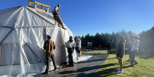 People building a geodome greenhouse.