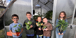 Children holding plants