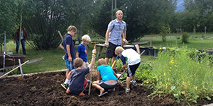 Teacher and student working in a garden